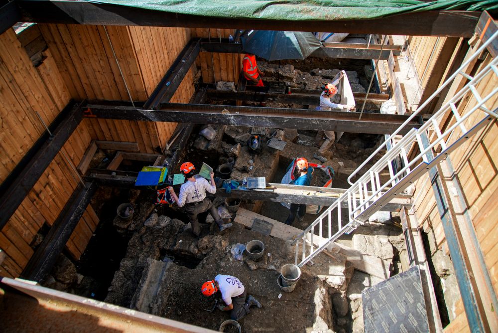 Archaeological workers wearing hard hats dig 13 feet underground during excavations outside NotreDame Cathedral in Paris June 1, 2026. (AP/Nicolas Garriga)