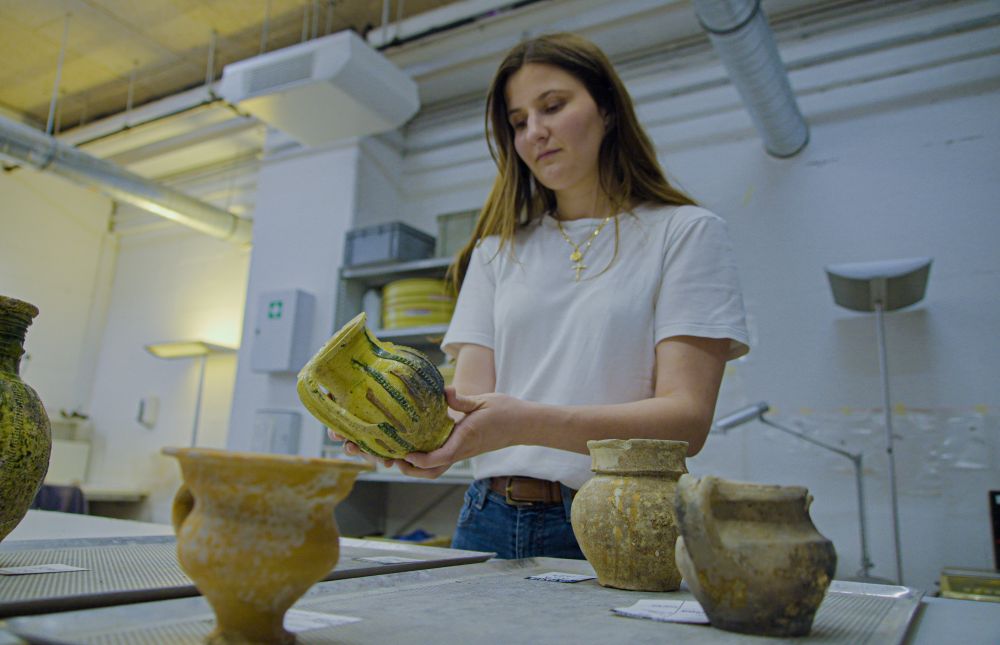 Archaeologist Valentine Breloux holds ceramic fragments discovered during excavations outside Notre Dame Cathedral in Paris June 1, 2026. (AP/Nicolas Garriga)