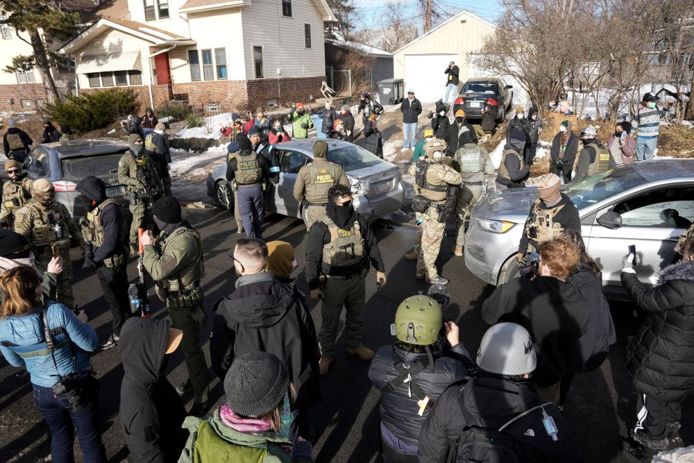 Federal agents stand by a damaged civilian's car hit by U.S. Immigration and Customs Enforcement agents in Minneapolis Jan.12, 2026. (OSV News/Reuters/Tim Evans)