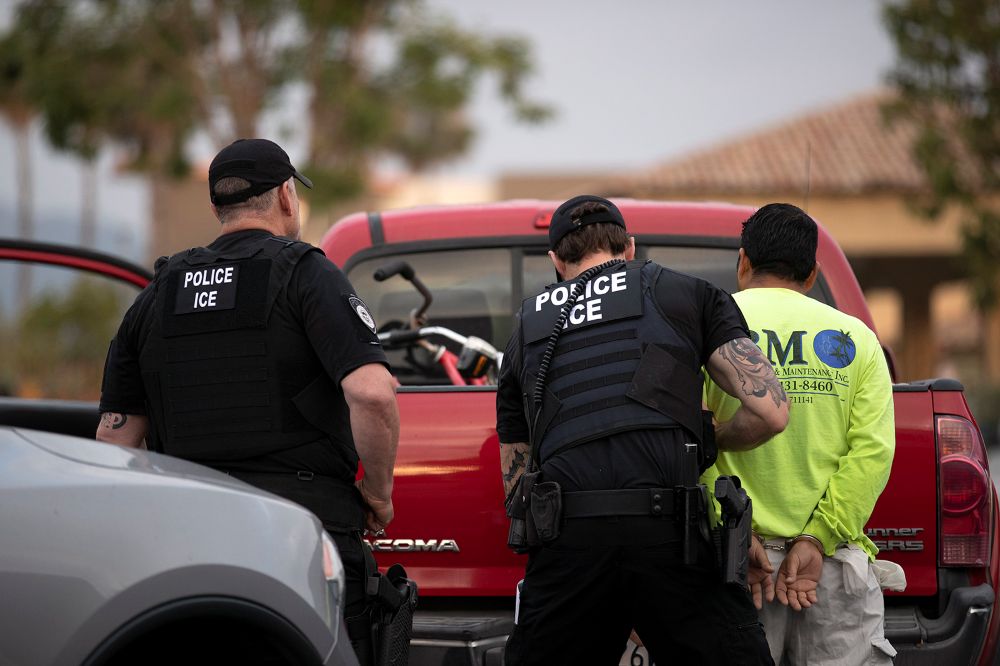 U.S. Immigration and Customs Enforcement officers detain a man during an operation in Escondido, Calif. (RNS/AP/Gregory Bull)
