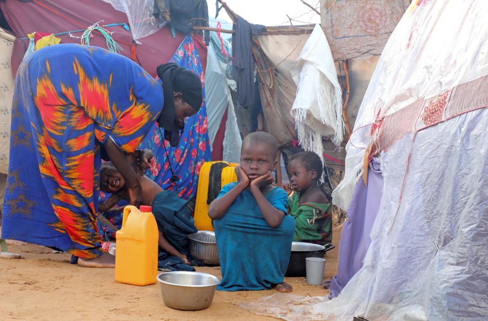 An internally displaced Somali family prepares breakfast outside their makeshift shelter in Mogadishu May 7, 2026. Experts say nearly 6.5 million people in Somalia are experiencing high levels of acute food insecurity and more than 1.8 million children are suffering from acute malnutrition because of recurrent drought, displacement, prolonged instability and insufficient resources. (OSV News/Reuters/Feisal Omar)