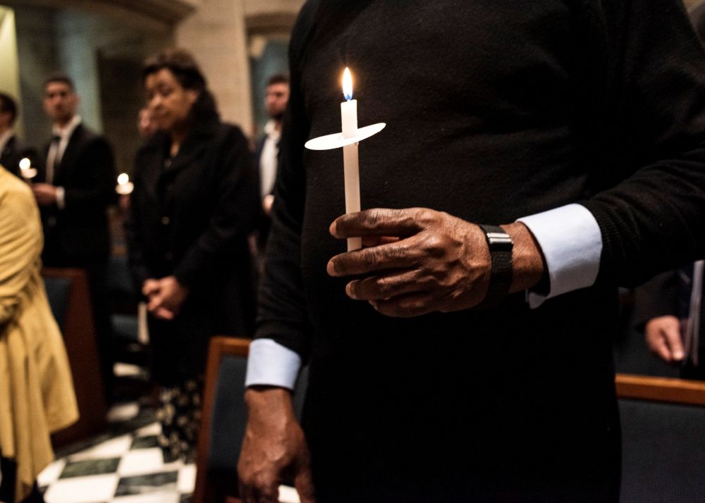 People at the Cathedral of the Most Blessed Sacrament in Detroit hold candles April 16, 2022, during the start of the Easter Vigil with then Detroit Archbishop Allen Vigneron as presider. (CNS/Detroit Catholic/Rosa Maria Zamarron)