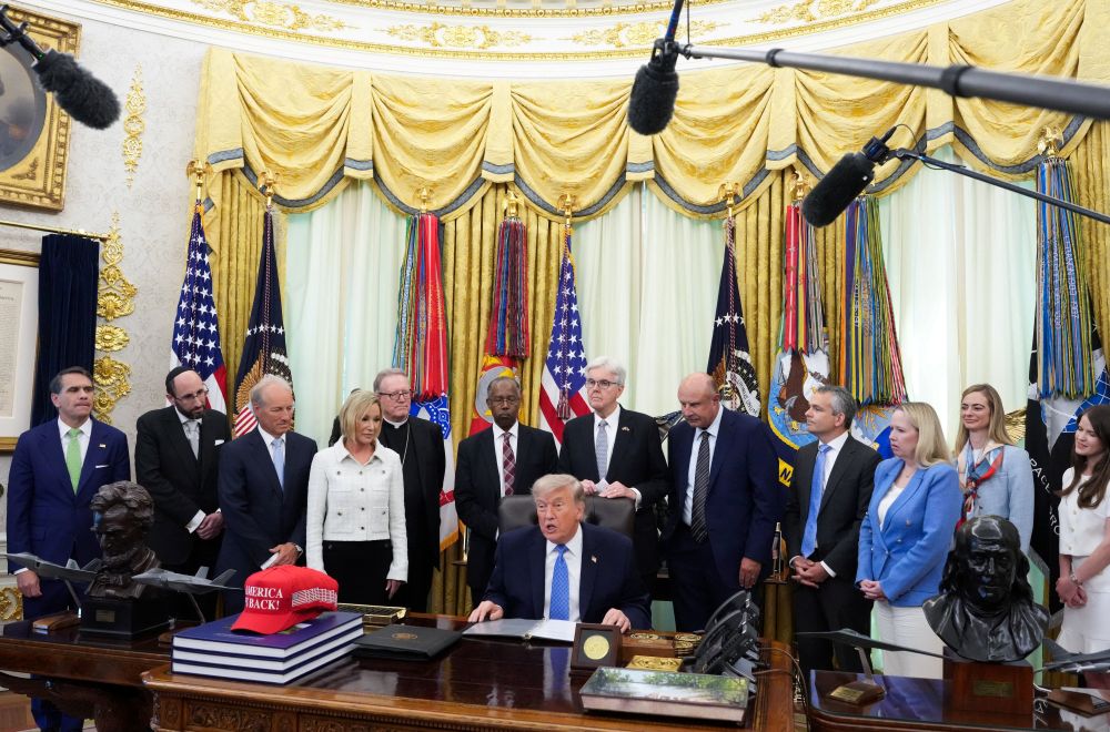 U.S. President Donald Trump speaks as the Department of Justice's Religious Liberty Commission presents a draft of its report to him in the Oval Office of the White House in Washington, June 26, 2026. (OSV News/Reuters/Ken Cedeno)