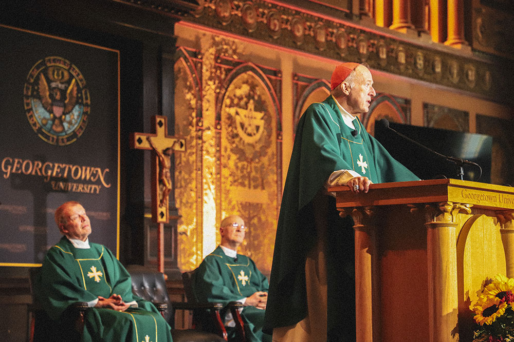 Washington Cardinal Robert McElroy presides at Mass during the Outreach conference June 20, 2026, in Gaston Hall at Georgetown University. (Courtesy of Outreach and America Media/Kevin Christopher Robles)
