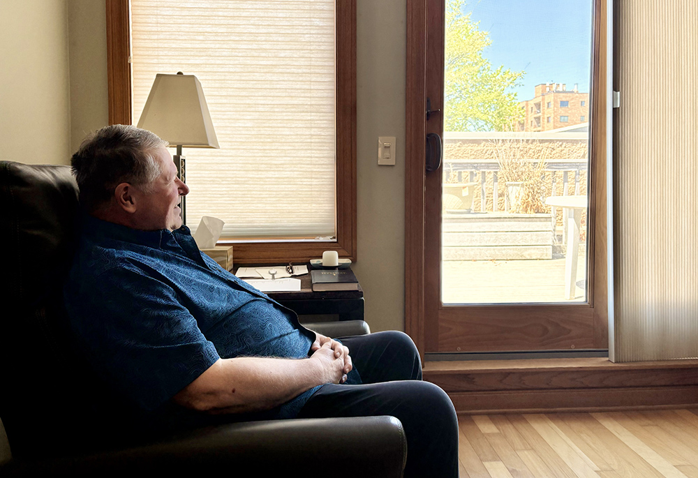 Author, composer and professor Fr. Michael Joncas sits in his apartment in St. Paul, Minnesota, May 2026. (NCR photo/Camillo Barone)