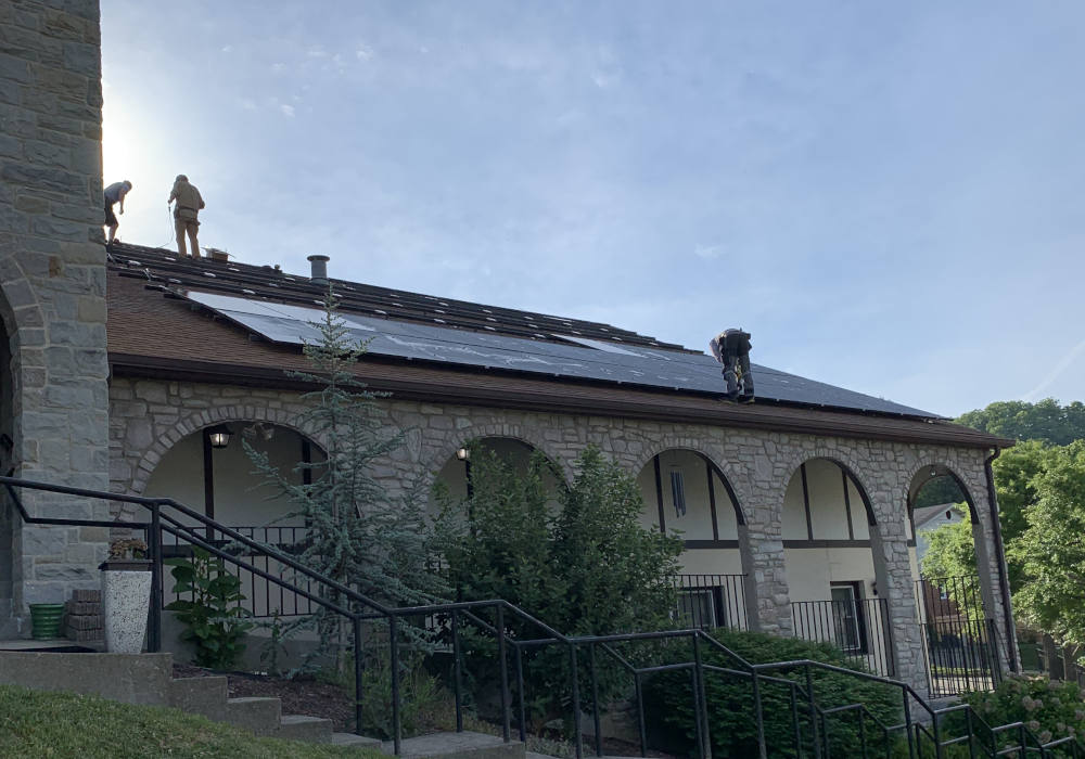 Workers install a solar array on the roof of Mother of Good Counsel Catholic Church, in Hazard, Kentucky, in May 2026. It is one of nearly 30 solar projects completed or in process in the Lexington Diocese. (Lexington Diocese/Joshua Van Cleef)