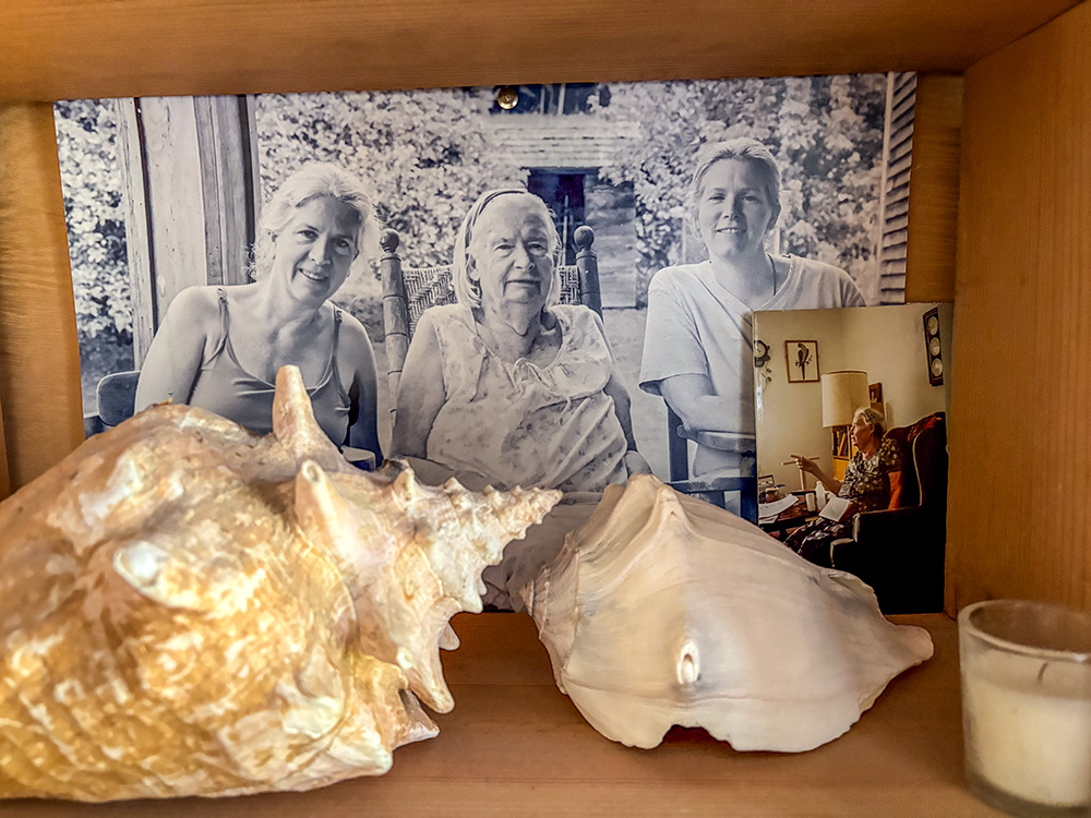 A shelf in Martha Hennessy's bedroom at Maryhouse Catholic Worker in New York on June 8, 2026, shows a picture of her, her mother Tamar and her sister Kate. (NCR photo/Camillo Barone)