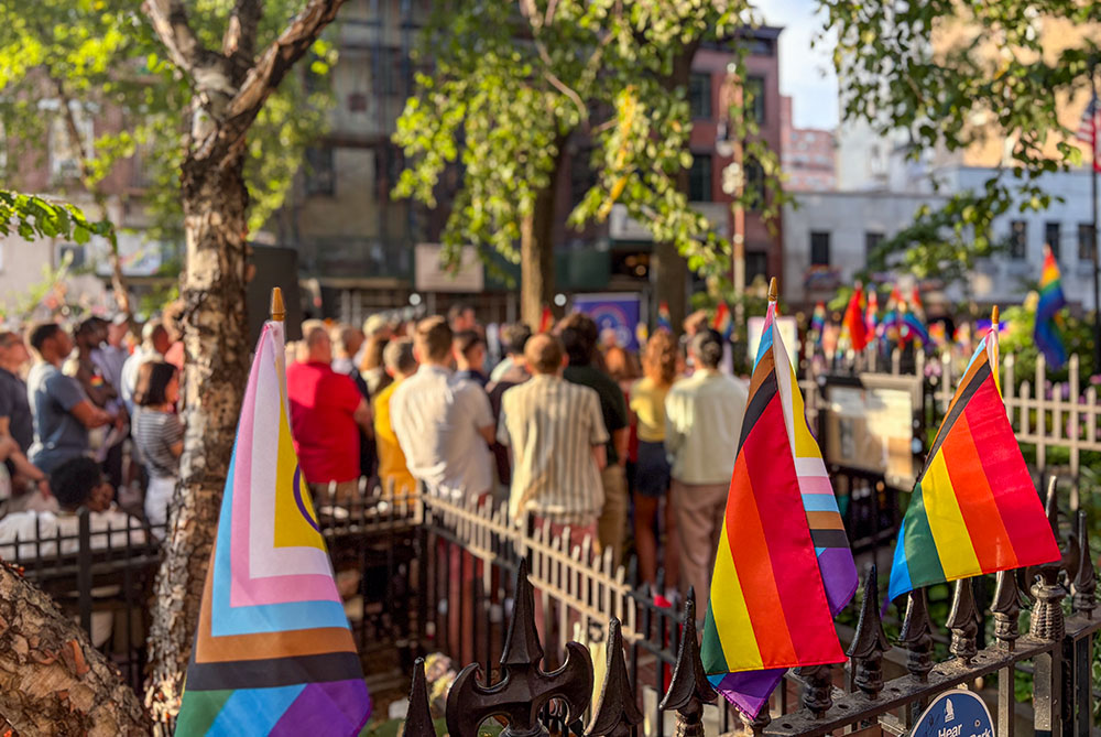 About 150 worshippers gathered at the Stonewall National Monument in Christopher Park in New York for an open-air Mass on June 25, 2026, steps away from the Stonewall Inn. (NCR photo/Camillo Barone)