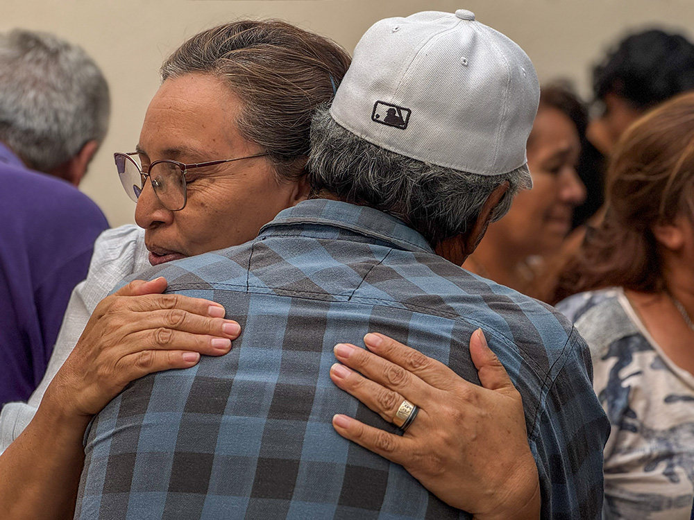 Sr. María Dolores Ramírez Ramírez, of the Carmelites of the Sacred Heart, hugs a father whose child is missing June 26, 2026 in Guadalajara, Mexico. (Courtesy of Casa Luisita)