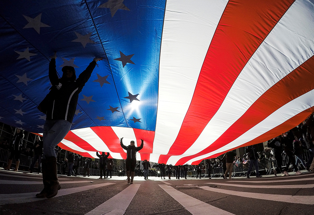 In this 2017 file photo, people in New York City carry the U.S. flag. (CNS/Reuters/Eduardo Munoz)
