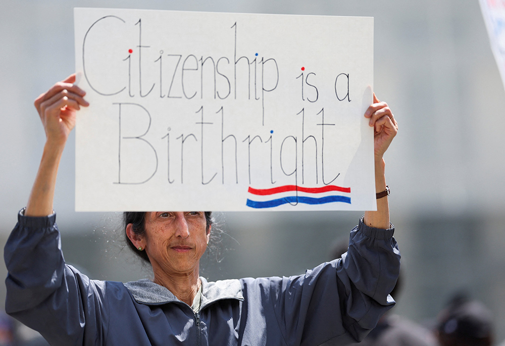 A demonstrator holds a placard during a protest outside the Supreme Court in May 2025. (OSV News/Reuters/Leah Millis)