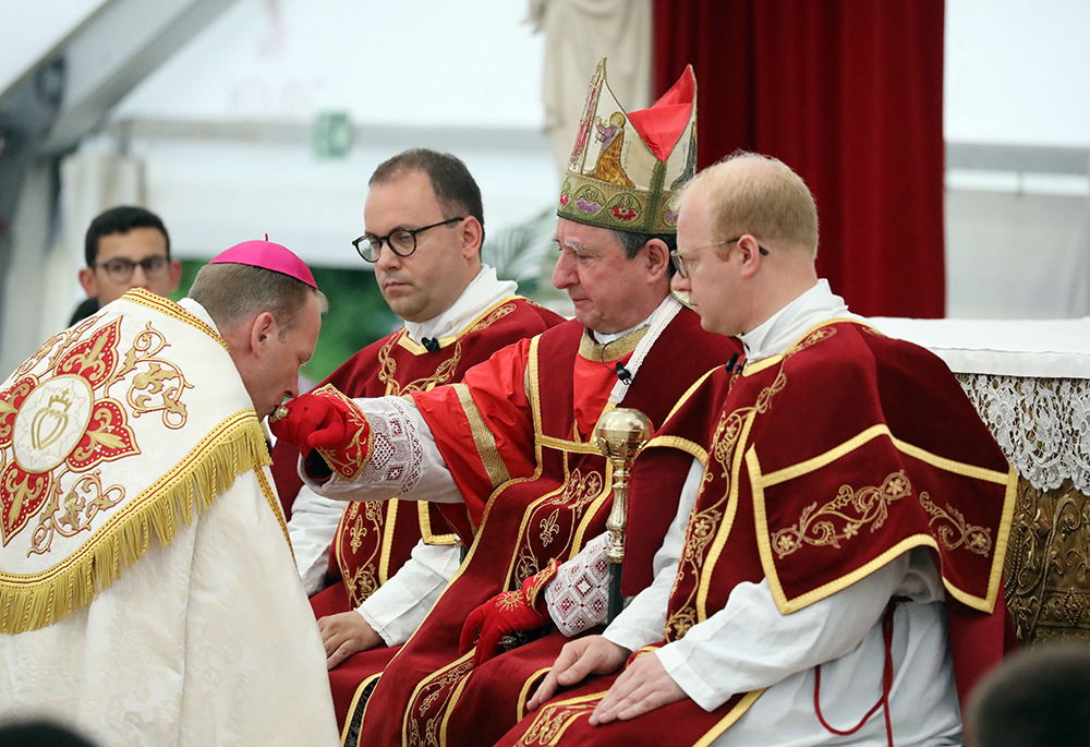 Newly consecrated Society of St. Pius X Bishop Michael Goldade is seen kissing the ring of Bishop Alfonso de Galarreta during an SSPX liturgical celebration July 1, 2026, in Écône, Switzerland. (OSV News/CPP)