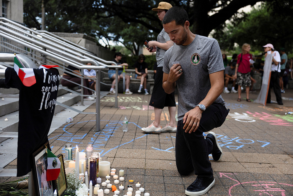 A man makes the sign of the cross at a makeshift memorial during a vigil in Houston July 11, 2026, in response to the fatal shooting of a Mexican motorist by an Immigration and Customs and Enforcement agent during a vehicle stop. (OSV News/Reuters/Antranik Tavitian)
