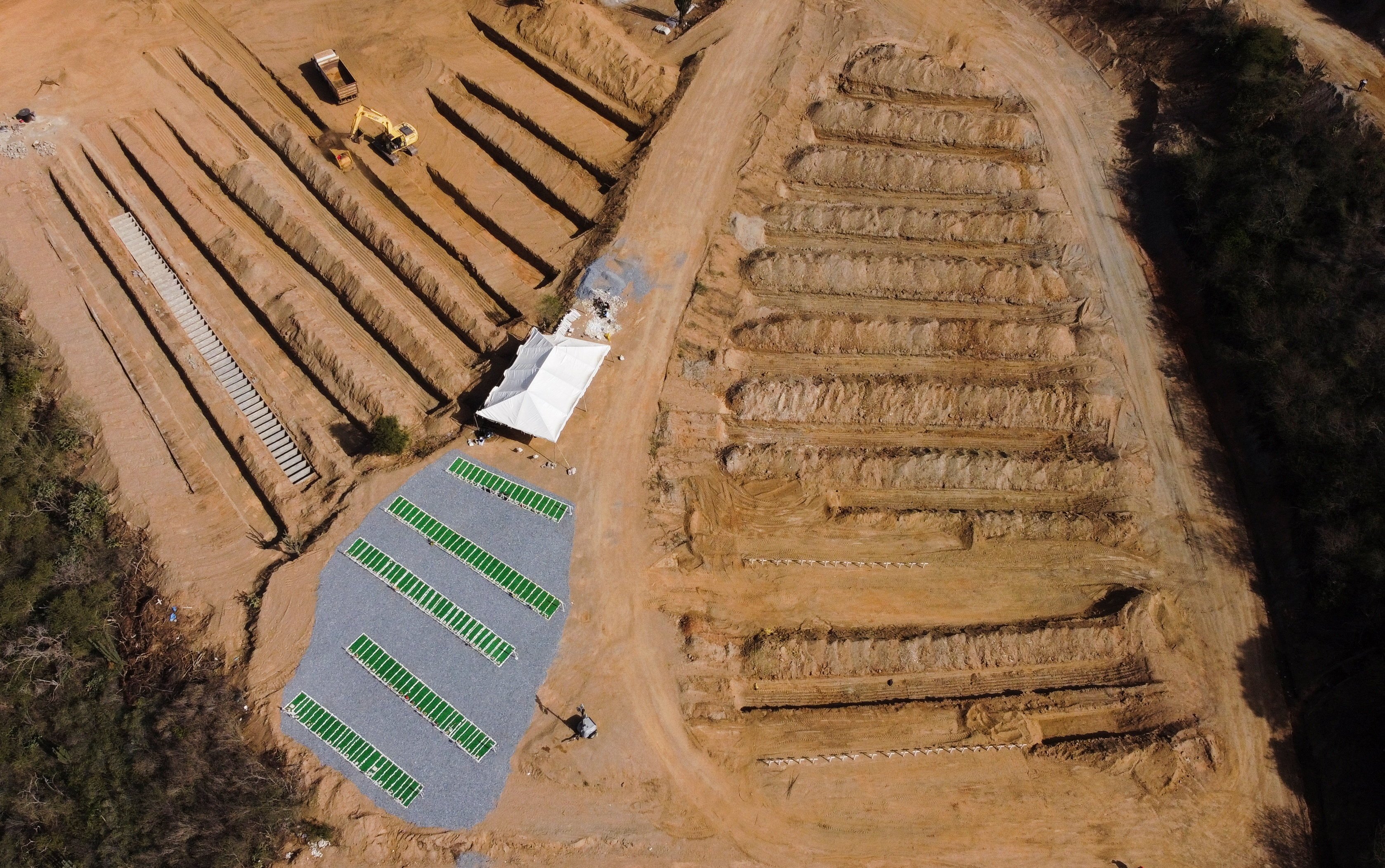 A drone view shows newly prepared graves for victims in La Guaira, Venezuela, July 22, 2026, following the aftermath of the June 24 earthquakes. Two catastrophic earthquakes hit Venezuela in quick succession June 24, leaving more than 5,000 dead with thousands still missing.