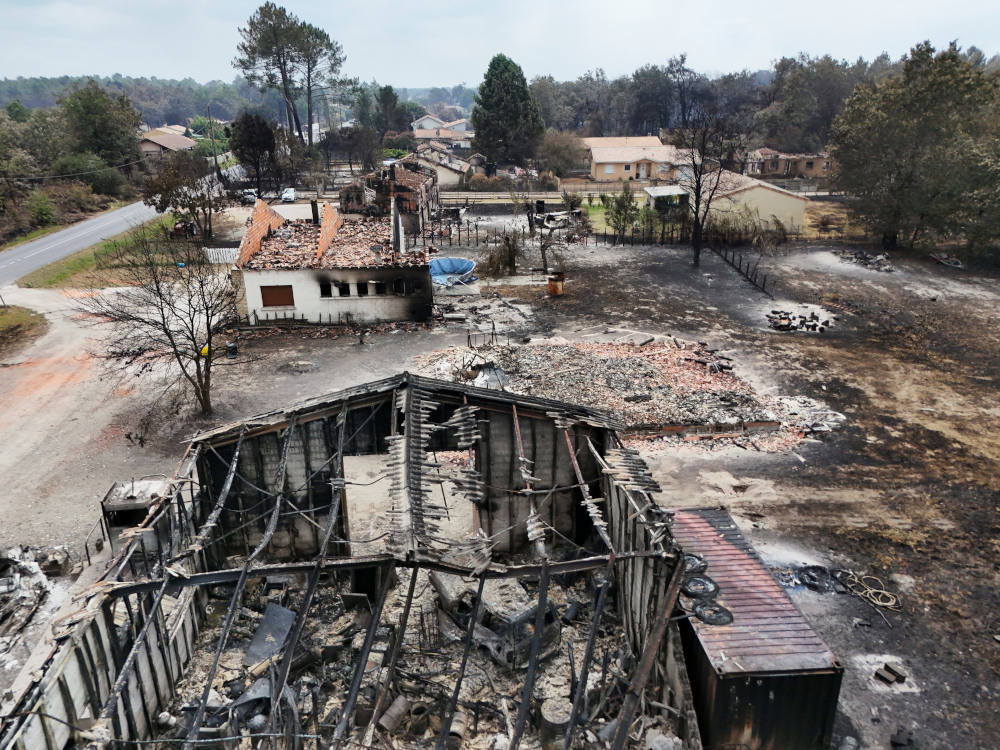 A drone view shows homes destroyed by wildfires in Le Porge, France, July 26, 2026. (OSV News photo/Manon Cruz, Reuters)