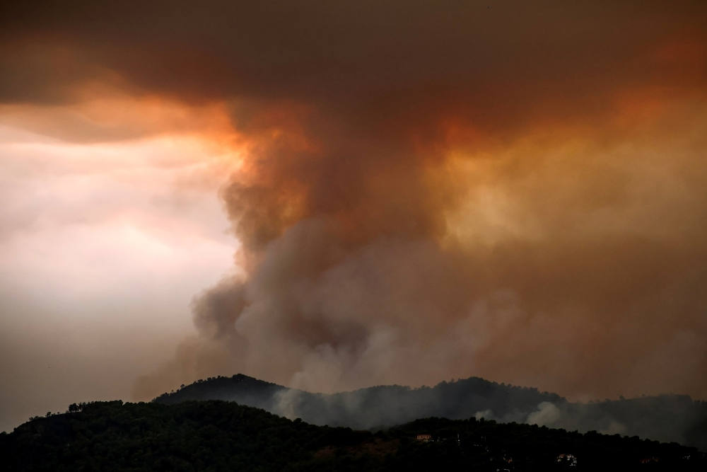 Smoke rises from a wildfire progressing in Betxi, Spain, July 26, 2026. Firefighters continue to battle massive wildfires in Spain and France that have forced hundreds of thousands to evacuate from their homes. (OSV News photo/Pedro Nunes, Reuters)