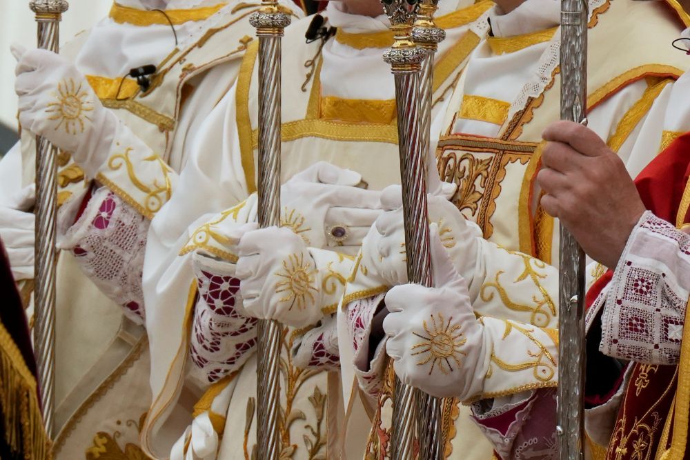 Four newly consecrated bishops hold their crosiers at the end of their consecration ceremony in a tent set up outside the Society of St. Pius X seminary in Écône, Switzerland, Wednesday, July 1, 2026. (AP Photo/Baz Ratner)