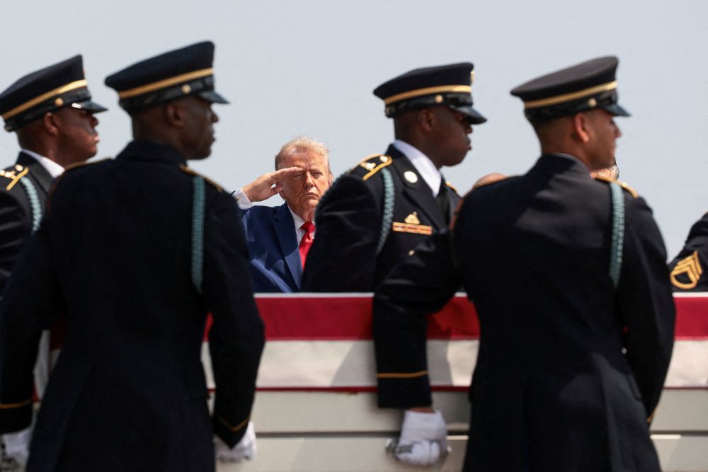 U.S. President Donald Trump salutes as members of the military carry the transfer case of U.S. Army Pvt. Isabella Gonzales during a dignified transfer of her remains at Dover Air Force Base in Delaware July 22, 2026. Gonzales was killed during an attack at Muwaffaq Salti Air Base in Jordan. (OSV News/Reuters/Evelyn Hockstein)