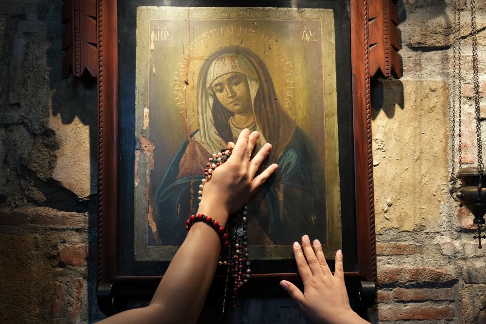 Catholics touch one of the images of Mary inside the Ephesus House, a replica of the House of the Virgin Mary in Ephesus, Turkey, at Alfonso town, Cavite province, Philippines on July 16, 2026. (AP/Aaron Favila)