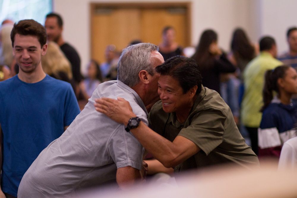 Person hugs another.
