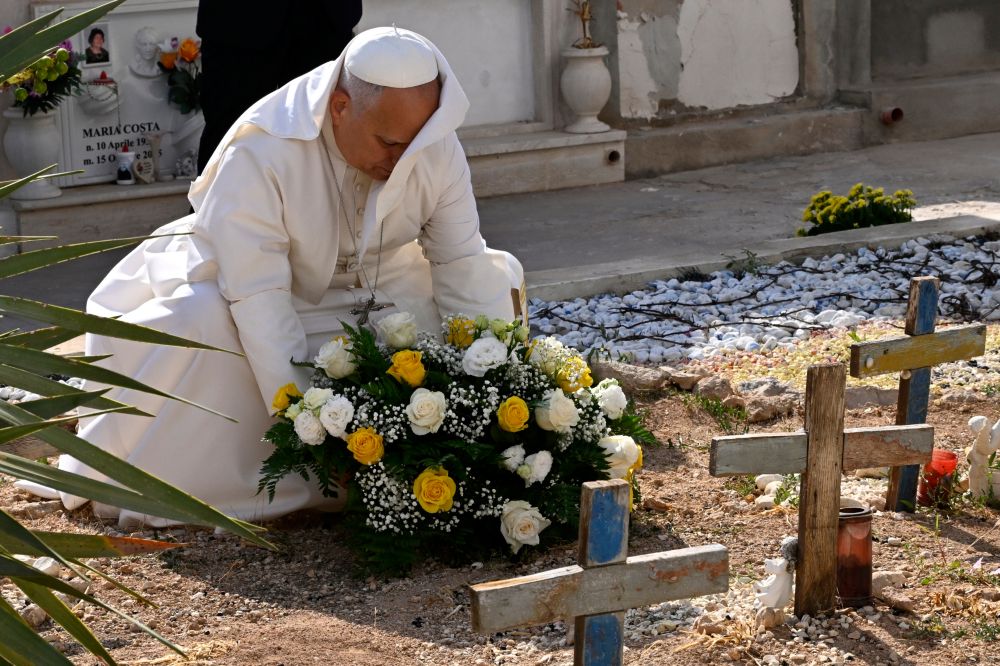 Pope Leo XIV pays tribute at the cemetery and on little Joussef's grave, in Lampedusa, Sicily, southern Italy, Saturday, July 4, 2026, during a one-day pastoral visit to an island that has become a symbol of the risks faced by migrants trying to reach Europe by sea. (Pool photo/Ciro Fusco, via AP)