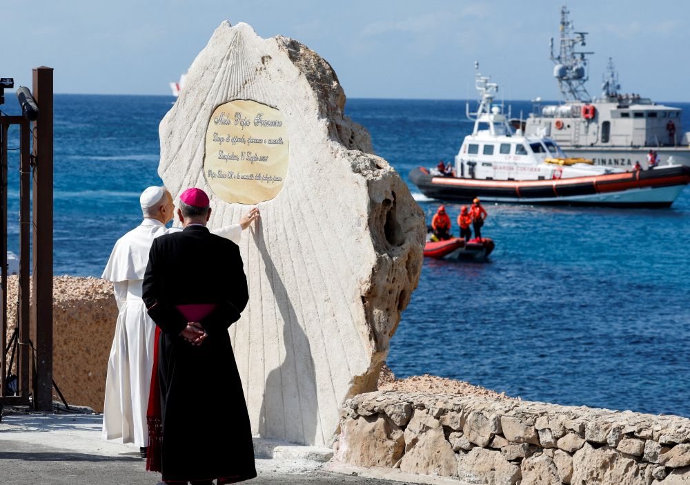 Pope Leo XIV blesses a plaque at Molo Favaloro in Lampedusa, Italy, and dedicates the pier to Pope Francis as he visits the island, a key entry point for migrants crossing the Mediterranean Sea, during a pastoral trip July 4, 2026. (OSV News/Reuters/Remo Casilli)