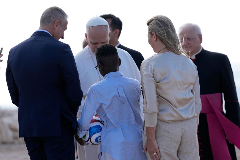 Pope Leo XIV meets Leo, a boy migrant, as he visits the Gateway of Europe monument in Lampedusa, Sicily, southern Italy, Saturday, July 4, 2026, during a one-day pastoral visit to the island long associated with the plight of migrants crossing the Mediterranean. (AP/Alessandra Tarantino)