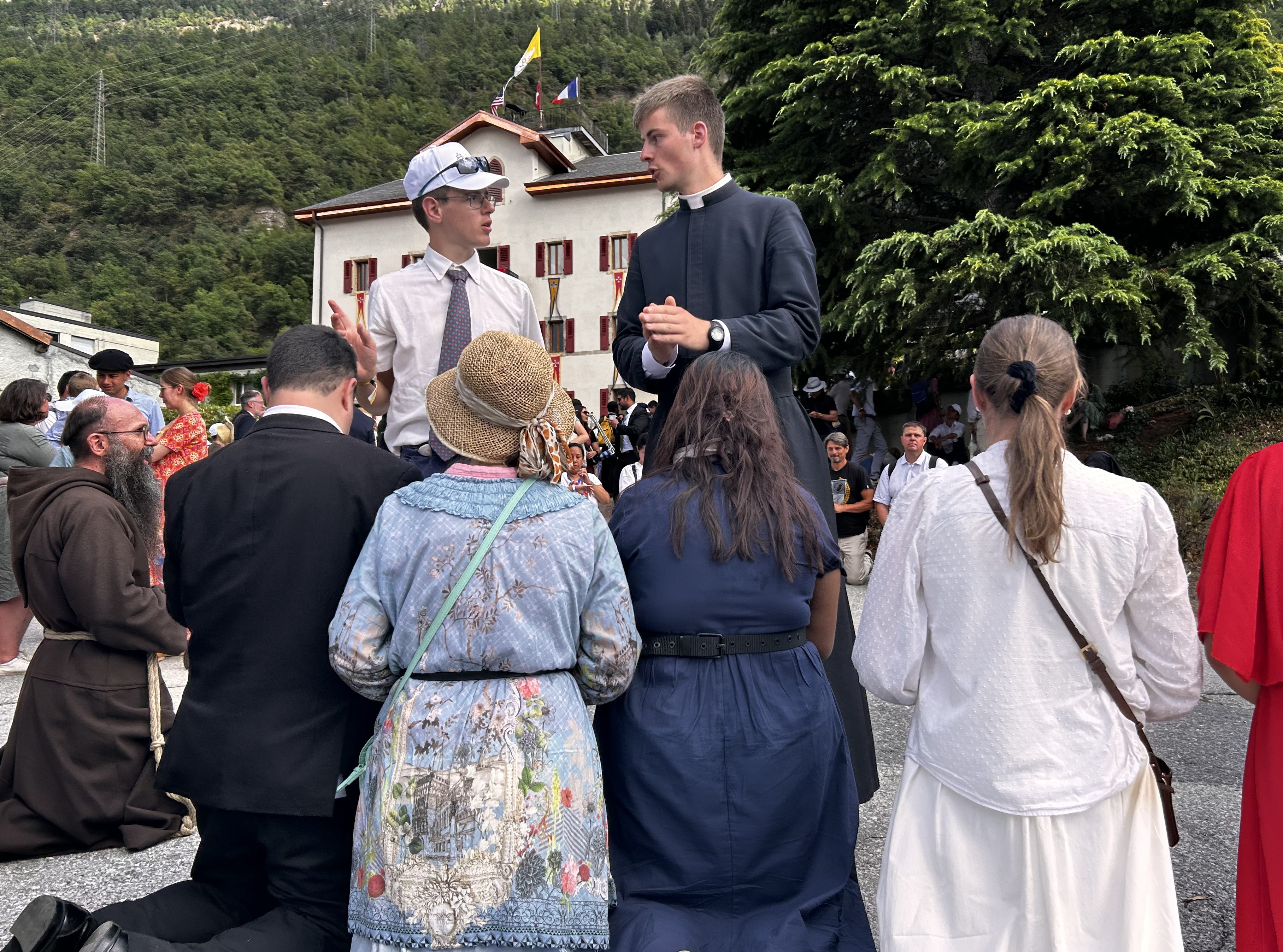 People kneel for a blessing after attending Mass for illicit bishop consecrations held at the international seminary for the Society of St. Pius X in Écône, Switzerland, July 1, 2026. (NCR photo/Justin McLellan)