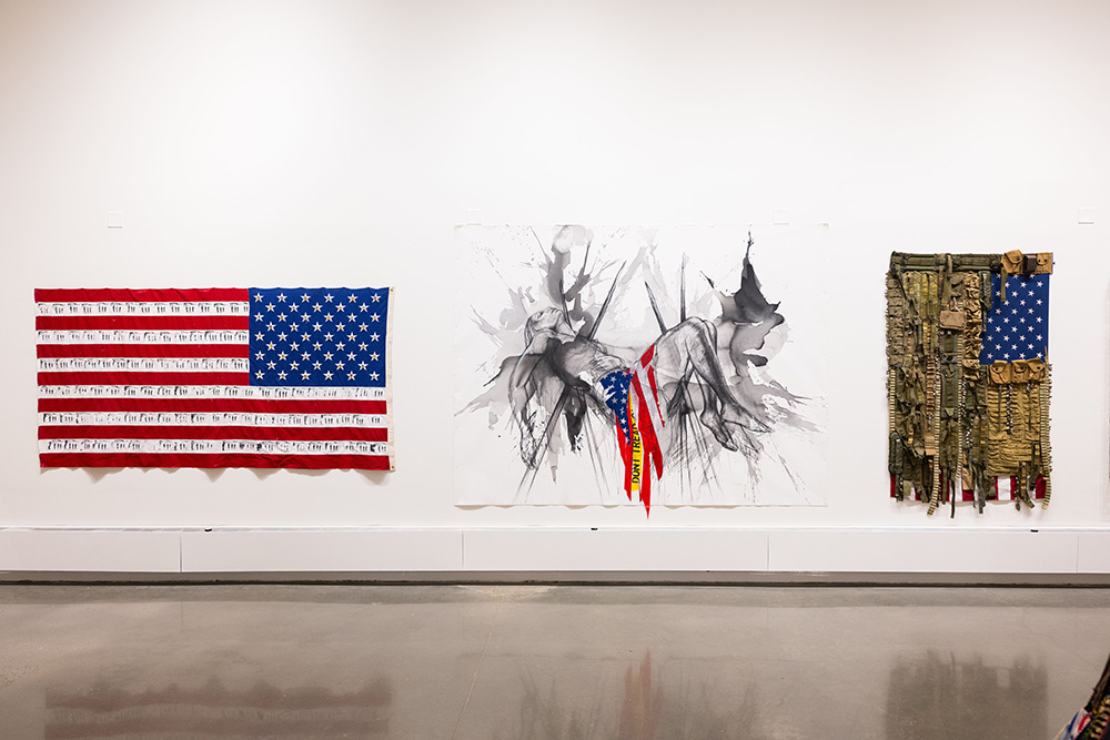 The Fairfield University Art Museum exhibition "For Which It Stands" includes these works at the university's Walsh Gallery. (Left): Danielle Scott, False Flag, 2020, photo transfer and found objects (shotgun shells) on US flag. Courtesy of the artist. © Danielle Scott. (Center): Imo Nse Imeh, and i'll be there with you, 2021, charcoal, India ink and conte crayon on unstretched canvas. Courtesy of the artist. © Imo Nse Imeh. (Right): Sara Rahbar, I don't trust you anymore, Flag #59, 2019, mixed media