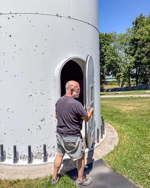 Benedictine Br. Joseph Byron walks inside the Portsmouth Abbey wind turbine June 17, 2026. (NCR photo/Camillo Barone)