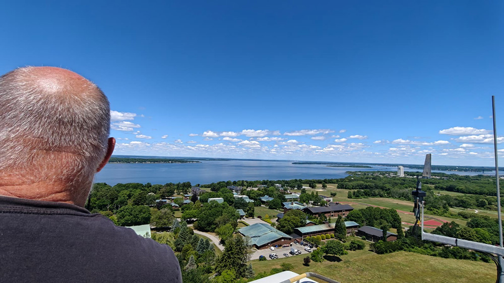 Benedictine Br. Joseph Byron admires the view from the top of Portsmouth Abbey's wind turbine in Aquidneck Island, Rhode Island, June 17, 2026. (Courtesy of Antony Parambi)