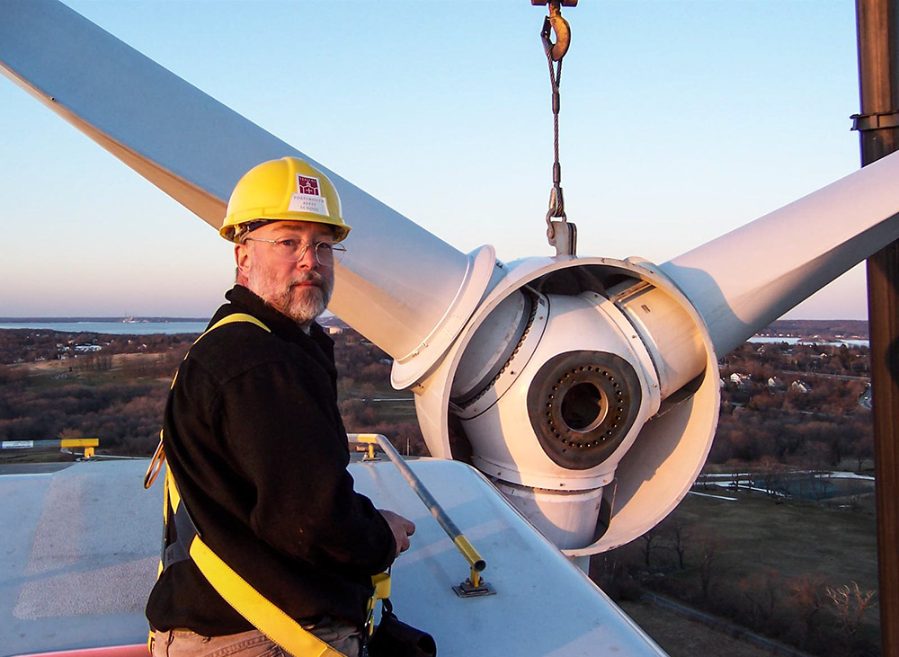 Benedictine Br. Joseph Byron, monk at Portsmouth Abbey and boarding school in Portsmouth, Rhode Island, stands on top of the abbey's wind turbine in March 2006. (Courtesy of Joseph Byorn)