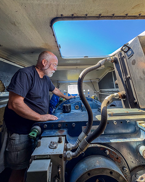 Benedictine Br. Joseph Byron inside the engine of Portsmouth Abbey's wind turbine June 17, 2026 (NCR photo/Camillo Barone)