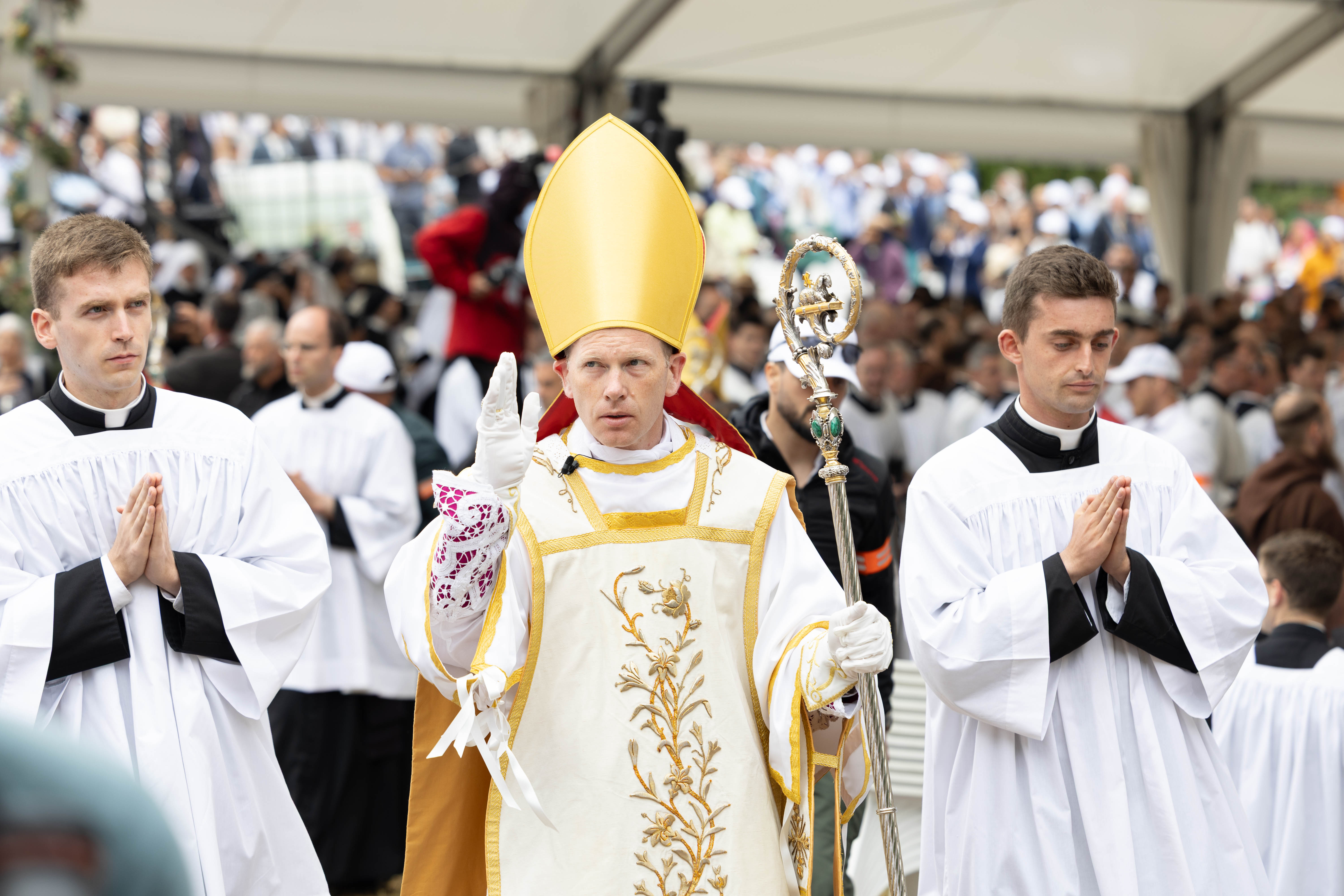 Excommunicated Bishop Michael Goldade, from St. Marys, Kansas, gives a blessing as he proceeds from an illicit consecration Mass in Écône, Switzerland, celebrated by the Society of St. Pius X on July 1, 2026. (Courtesy of Society of St. Pius X)