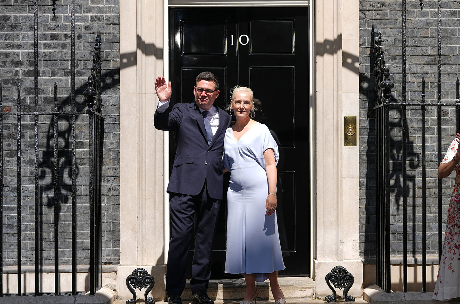 Britain's new prime minister, Andy Burnham, and his wife, Marie-France van Heel, wave as they arrive at 10 Downing Street in London, Monday, July 20, 2026.(AP/Kirsty Wigglesworth)