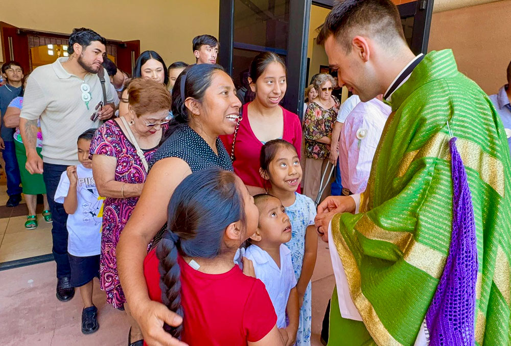 Fr. Mattia Ferrari, right, greets parishioners after celebrating Mass at Our Lady of Guadalupe Church, on June 21, 2026, in Mecca, Calif. (Courtesy of Catholics in Communion)