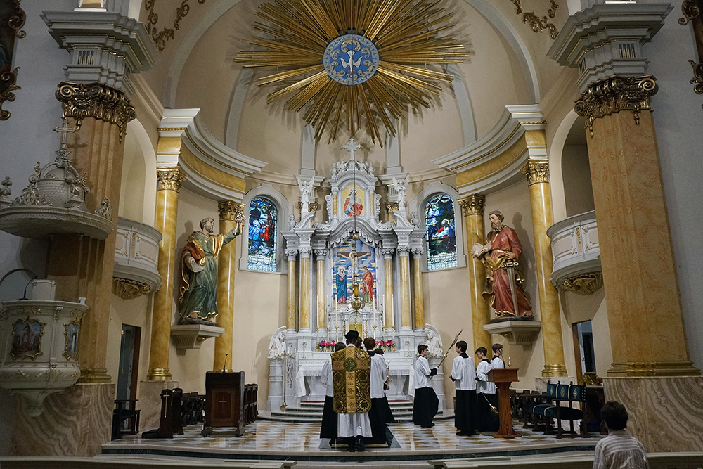 Fr. John Ubel, pastor of the Church of Saint Agnes, processes into the sanctuary with altar servers at the start of one of the Catholic parish’s Latin Masses in St. Paul, Minn., June 28, 2026. (AP Photo/Giovanna Dell’Orto)
