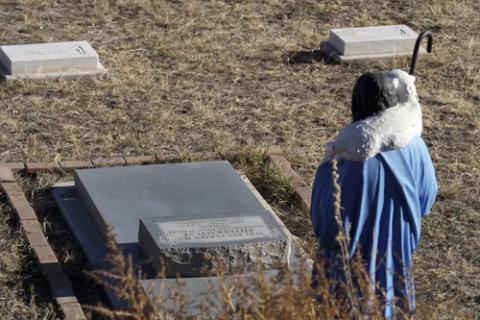 Grave with small statue.