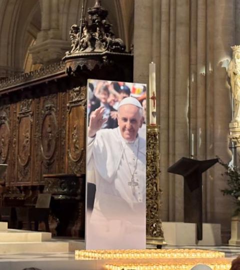 A large photograph of Pope Francis stands beside the lectern at Notre-Dame de Paris during Mass April 23.