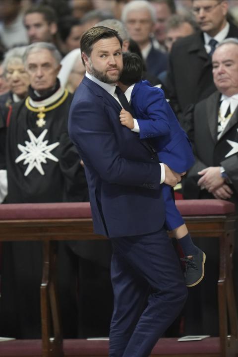 U.S. Vice President JD Vance, center, with daughter Mirabel, back to camera, and wife Usha with son Vivek, left, attends a Good Friday service inside St. Peter's Basilica at the Vatican, April 18, 2025. (AP Photo/Alessandra Tarantino)