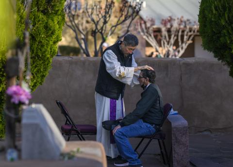 Daniel Arona of Albuquerque receives a blessing from Friar Sebastian Lee. Thousands of pilgrims make their way to El Santuario De Chimayo in Northern New Mexico on Good Friday, April 18, 2025 in Chimayo, N.M. (AP Photo/Roberto E. Rosales)