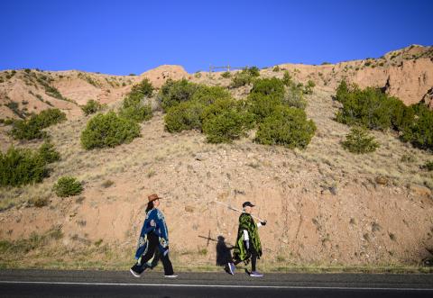 Dianne DeLeon, left, and her mother Victoria Trujillo walk along Juan De Medina Rd on their way to the El Santuario De Chimayo in Northern New Mexico on Good Friday, April 18, 2025. Chimayo, N.M. (AP Photo/Roberto E. Rosales)