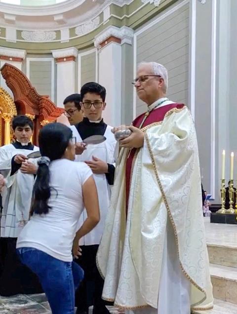 Then-Bishop Robert Prevost distributes Communion during Mass in Chiclayo, Peru, in this screengrab from a video released in 2023. (OSV News/Lambayeque Regional Governor Jorge Perez Flores via Reuters)