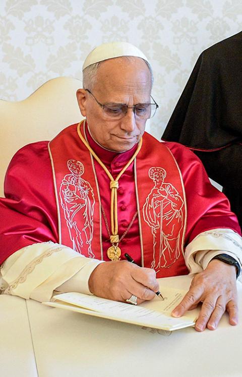 Pope Leo XIV signs his first apostolic exhortation, Dilexi Te, in the library of the Apostolic Palace at the Vatican Oct. 4, 2025. The exhortation was released Oct. 9. (CNS/Vatican Media)