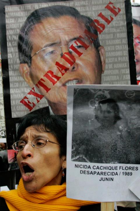 During a march in Lima, Peru, Sept. 27, 2007, a woman carries a picture of a victim murdered during the term of former Peruvian President Alberto Fujimori. Chile extradited Fujimori Sept. 22, 2007, paving the way for a trial in Peru. (CNS/Reuters/Enrique Castro-Mendivil)