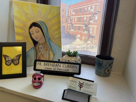 A painting of Our Lady of Guadalupe, a butterfly and a few other decorative trinkets sit at the windowsill of Dominican Fr. Brendan Curran's office at The Resurrection Project in Pilsen, Chicago, Oct. 27, 2025. (NCR photo/Camillo Barone)