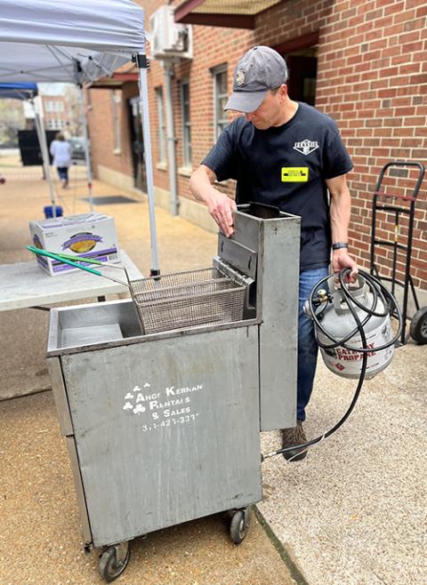 A parishioner at St. Margaret of Scotland Catholic Church preps the oil fryer for the annual Lenten fish fry in March 2023. (St. Margaret of Scotland Catholic Church)