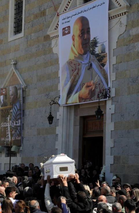 People carry the coffin of Fr. Pierre al-Rahi during his funeral in Qlayaa in southern Lebanon March 11. The Lebanese Maronite Catholic priest died March 9 after injuries from Israeli tank fire on a house in Qlayaa following an escalation between Hezbollah and Israel amid the U.S.-Israeli war with Iran. (OSV News/Reuters/Karamallah Daher)