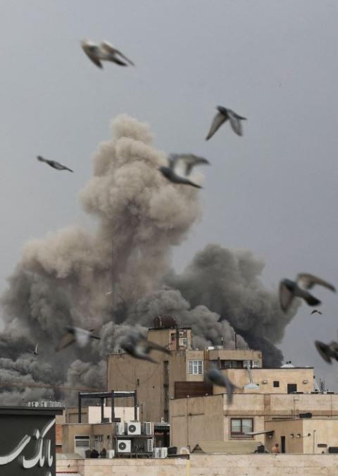 Birds fly as smoke rises following an explosion, after Israel and the U.S. launched strikes on Iran, amid the U.S.-Israel war with Iran, in Tehran, Iran, March 2. (OSV News/West Asia News Agency via Reuters/Majid Asgaripour)