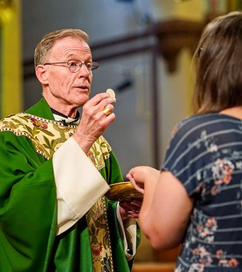 Archbishop John Wester of Santa Fe, N.M., distributes Communion during the closing Mass for the Outreach LGBTQ Catholic Ministry Conference at the Church of St. Paul the Apostle in New York City June 18, 2023. (OSV News/Gregory A. Shemitz)